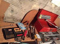 Wide view showing assortment of tools and red metal toolbox