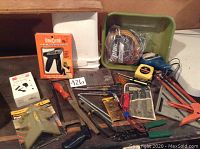 Front view of assortment showing tools and two plastic storage bins