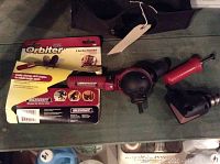 Milescraft Drill Orbiter tool in original packaging, showing red and black device with adjustable handle.