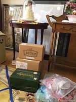 Overall lot view showing display dome doll, original boxes, table setting