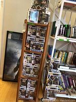 Multiple boxed Funko Pop figures arranged on a wooden ladder-style display