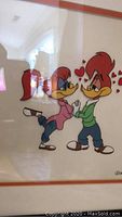 Framed serigraph cell featuring Woody and Wendy Woodpecker, titled 'Love Birds' by Walter Lantz, with clear cartoon character details and some heart icons, prominently displayed and in good condition.