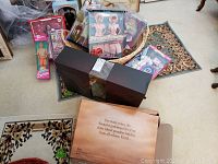 Overview of lot showing Ken doll, boxed accessories and wicker basket
