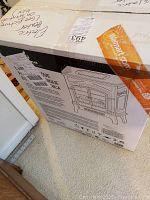 Boxed electric fireplace heater with vintage stove design, showing original packaging and Walmart label.