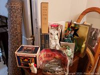 Overview of multiple items: theatre boxes, GWTW figurine, books, dolls, wooden chicken