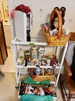 Three-tier white metal shelf displaying entire lot