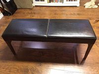 Full top-down view of the rectangular bench showing vinyl cushioned top and wooden legs.