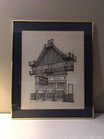 Framed signed print showing Massey Hall from an angled frontal view with clear architectural detailing.