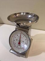 Front view of Polder kitchen scale showing dial and chrome weighing dish.