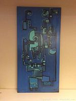 Full view of abstract painting showing geometric blue shapes on a blue background.