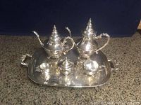 Full view of the silver tea set on tray including coffee pot, teapot, creamer, sugar bowl