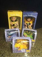 Five boxed Anne Geddes baby dolls: Baby Bees, Baby Sunflowers, and three Baby Butterflies.