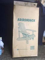 Box with printed Adirondack chair image and brand name in green text.