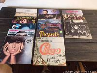 Overview of all 15 vinyl albums arranged on table, showing variety of artists and cover art.