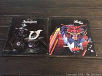 Front covers of two Judas Priest vinyl albums. Left album shows samurai helmet artwork with 'The Best of Judas Priest' title; right album features colorful robotic demon face.