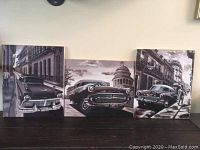 View of all three paintings displayed horizontally showing vintage cars and urban scenes