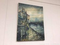 Front view of the unframed vintage oil painting hung on wall showing full composition with river, bridge, and buildings.