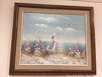 Full framed painting viewed head-on showing the woman in white dress by the seaside with flowers and birds in soft pastel colors.