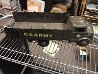 Side and top view of vintage green metal US Army toy truck showing flatbed, missing one wheel