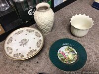 Overview photo showing all four porcelain items: cake platter, Lenox vase, Wade England plate, Capeans vase.