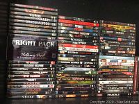 Wide view of stacked DVDs showing variety of horror titles and collection sets such as Fright Pack.