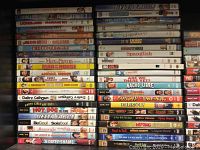 Shelf filled with approximately 50 comedy DVDs showing titles and spines clearly visible.