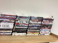 Photo showing stacked and aligned romance movie DVDs, titles visible such as 'The Mitty', 'What Women Want', 'The Tracey Fragments', 'GIA', 'Boys on the Side', and 'Couple Couplets'.