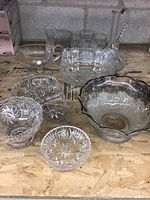 Overview of multiple crystal glassware pieces including bowls, dish, vase, and a rectangular box.