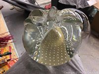 Photo showing the bottom of one glass art piece with bubble pattern and signature.