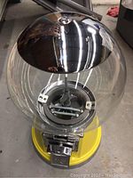 Top view of bubble gum machine showing clear globe and chrome metal lid.