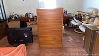 Front view of roll-up door wooden cabinet showing closed door and wood finish.
