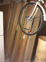 Assorted scrap wood and trim pieces stacked vertically, including boards and paneling.