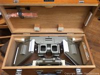 Stereo meter inside the wooden case with the instrument fully visible showing the binocular lenses and adjustment mechanisms.