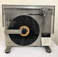 Front view of turntable with platter loaded and dust cover closed
