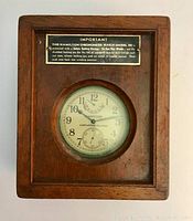 Front of closed wood case showing plaque and watch dial