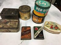 Eight vintage tins with varied designs including coffee, tobacco, shoe polish and decorative boxes.