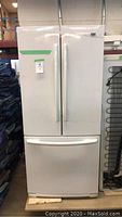 Front view of white Maytag French-door refrigerator with bottom freezer drawer