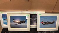 Four framed airplane art prints grouped together showing their size and style