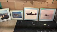 Four framed airplane art prints lined up, two larger and two smaller.