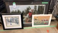 Three prints displayed together including the large Paul Calle framed print with dog and bird, John Metz framed winter scene print, and unframed Canada Geese print.