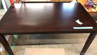 Top view of rectangular dark brown wooden dining table.