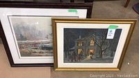Two framed prints by Frank Panabaker shown together on floor: one depicting a natural bird scene with water and trees, the other a house at night in winter with people approaching it.