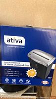 Box showing Ativa paper shredder branding and specifications highlighting 6 sheet diamond-cut shredding and other features.