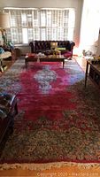 Full room view of rug under coffee table and sofa