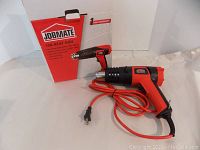 Heat gun displayed with original red and white box labeled 'Job Mate 10A Heat Gun' showing 1-year warranty and key features