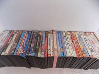 Photo showing the full set of 40 DVDs arranged side-by-side, titles facing up, revealing mostly comedy genre.