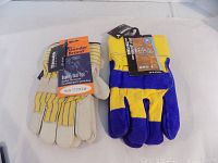Two new pairs of work gloves shown side by side on a white background, one yellow and blue and one yellow and white with Gander Brand label.