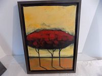 Front view of framed abstract canvas painting showing red stylized trees on yellow background