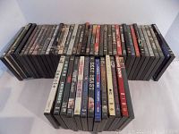 Overview of about 50 DVDs displayed in rows showing mixed genres and a variety of cases.