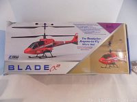 Box front showing E-Flite Blade CX2 red micro helicopter graphic and branding.